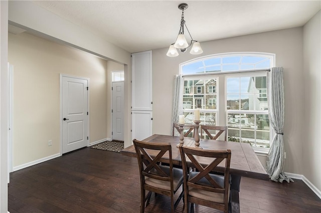 dining space featuring an inviting chandelier and dark hardwood / wood-style floors