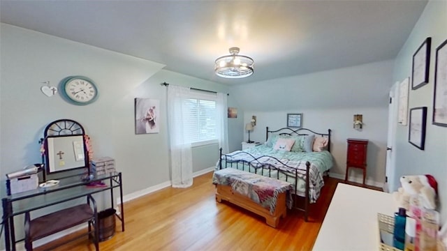 bedroom featuring hardwood / wood-style flooring and vaulted ceiling