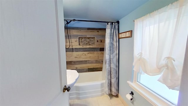 bathroom with tile patterned flooring and shower / tub combo