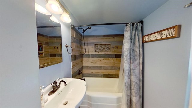 bathroom with sink and shower / bathtub combination with curtain