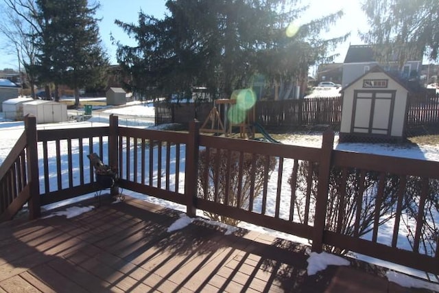 deck featuring a storage unit and a playground