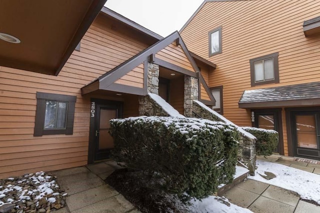 view of snow covered property entrance