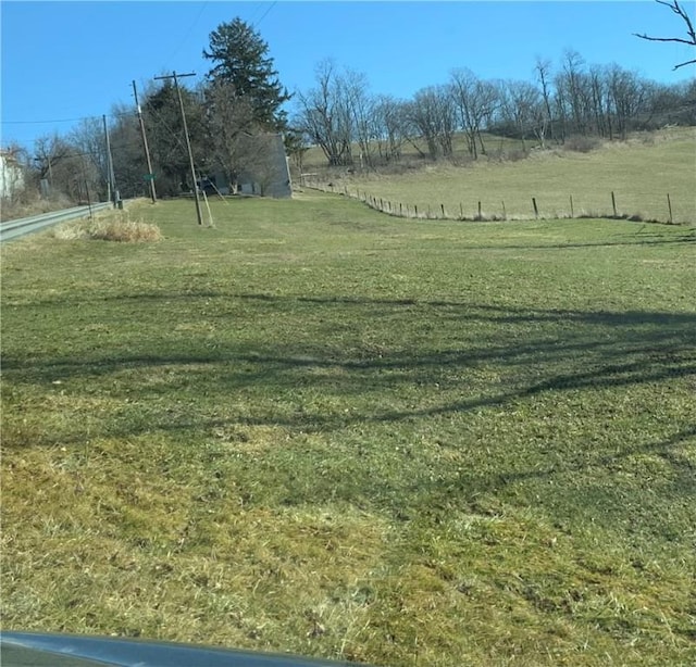 view of home's community featuring a rural view and a lawn