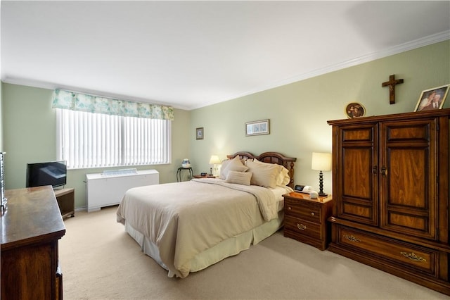 carpeted bedroom featuring crown molding and radiator heating unit