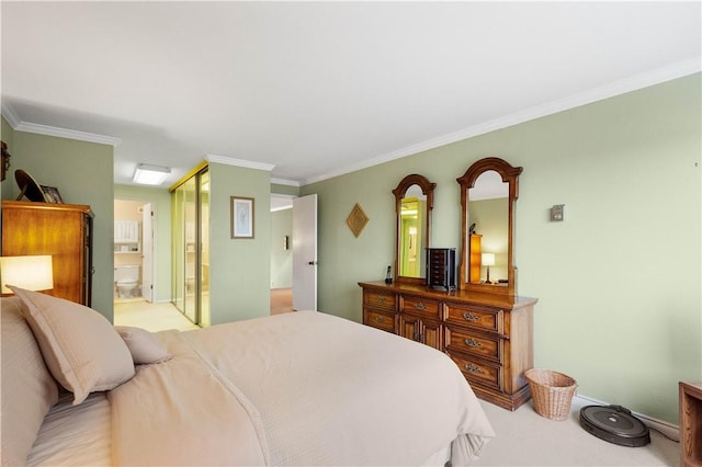 bedroom featuring light colored carpet, ornamental molding, ensuite bathroom, and a closet