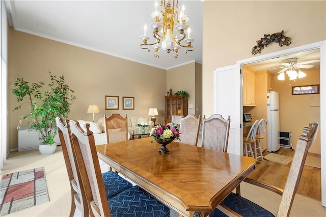 dining area featuring crown molding, light hardwood / wood-style flooring, and ceiling fan