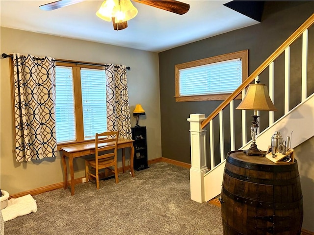 carpeted office space with plenty of natural light and ceiling fan