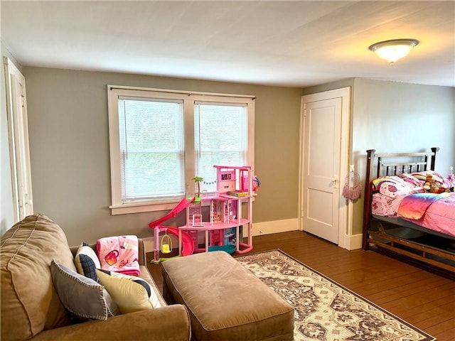 bedroom with dark hardwood / wood-style floors