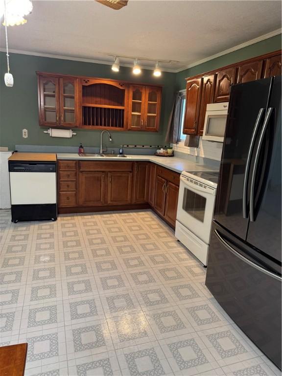 kitchen featuring ornamental molding, sink, pendant lighting, and white appliances