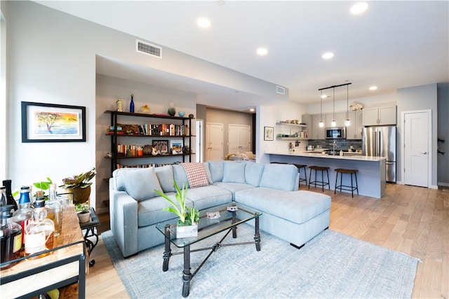 living room with light hardwood / wood-style flooring