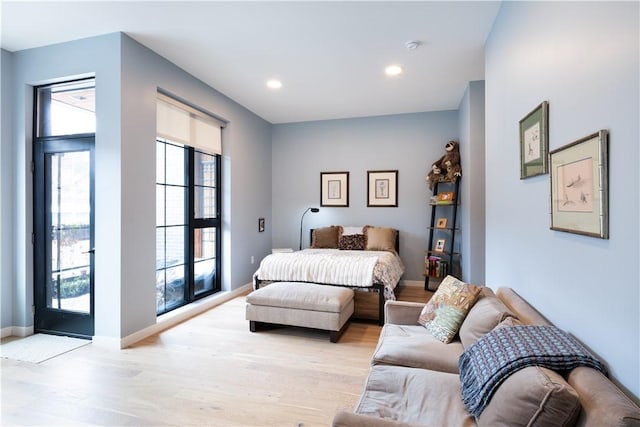 bedroom with access to outside and light hardwood / wood-style flooring