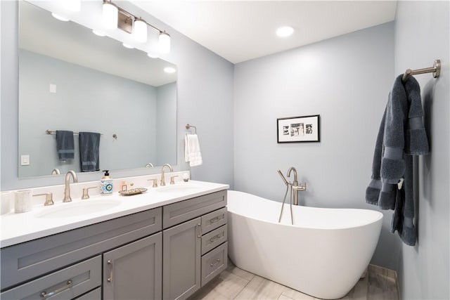 bathroom featuring vanity and a bath