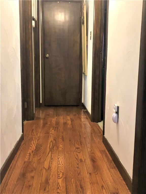 hall with dark hardwood / wood-style floors