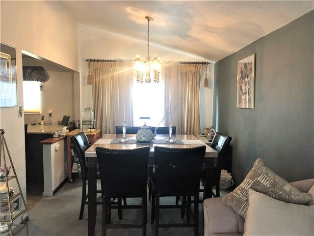 dining area featuring an inviting chandelier and vaulted ceiling