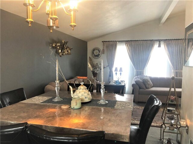 dining room with vaulted ceiling with beams