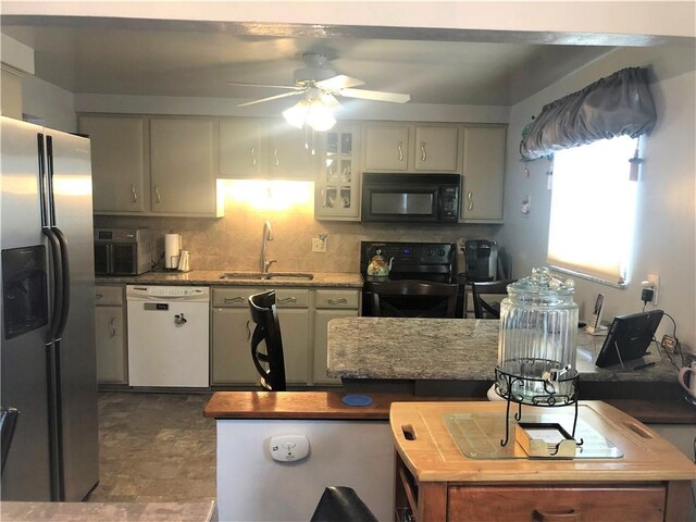 kitchen with backsplash, ceiling fan, sink, and black appliances