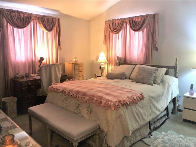 bedroom with vaulted ceiling and carpet