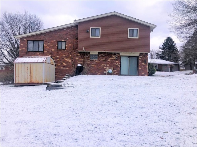 view of snow covered back of property