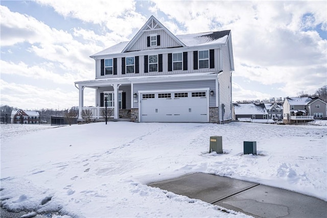 view of front of home featuring stone siding, a porch, board and batten siding, and an attached garage