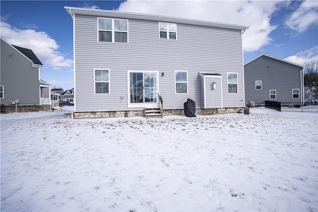 snow covered back of property with entry steps