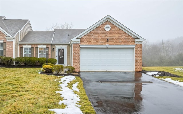 view of front facade with an attached garage, a front lawn, concrete driveway, and brick siding