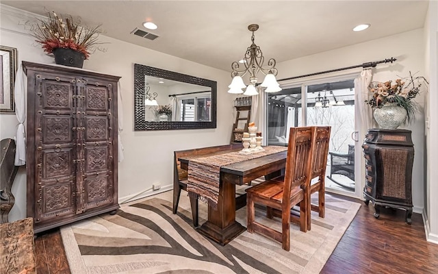 dining room featuring dark hardwood / wood-style floors, a chandelier, and a wealth of natural light