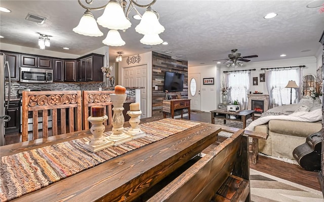 dining area with ceiling fan and a textured ceiling