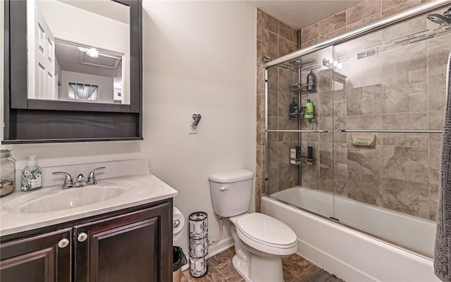 full bathroom featuring toilet, vanity, and bath / shower combo with glass door