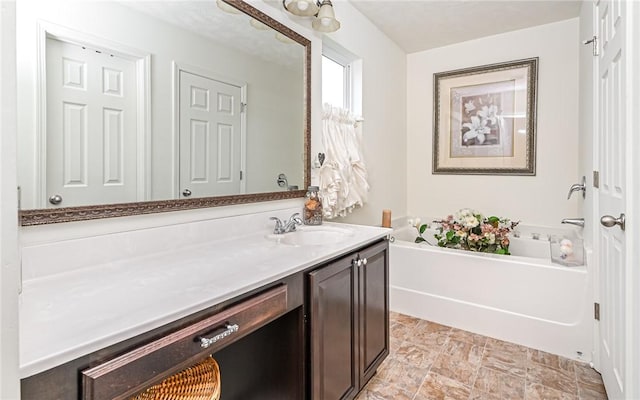 bathroom with vanity and a bath