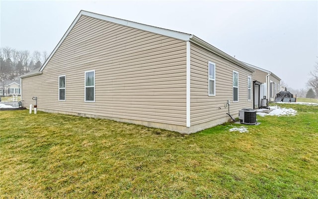 view of home's exterior featuring central AC and a lawn