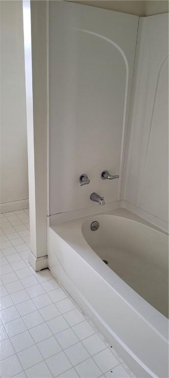 bathroom featuring tile patterned flooring and shower / washtub combination