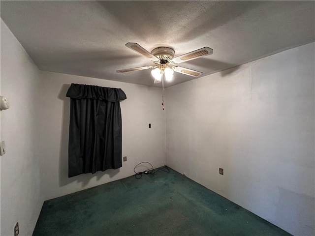 carpeted empty room with a textured ceiling and ceiling fan