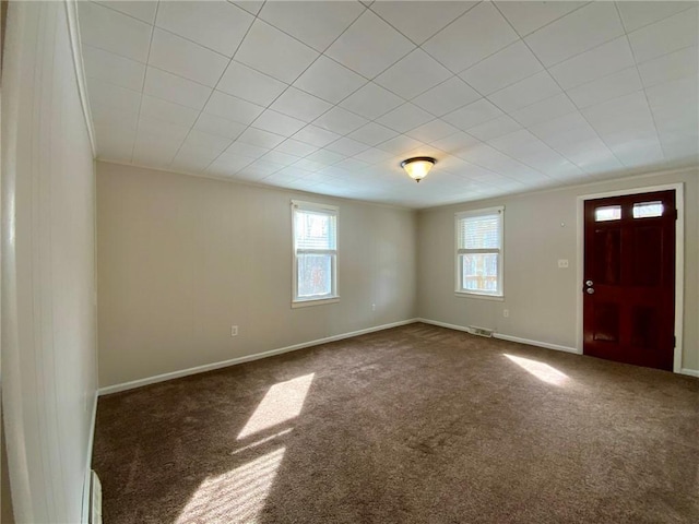 entryway with dark carpet