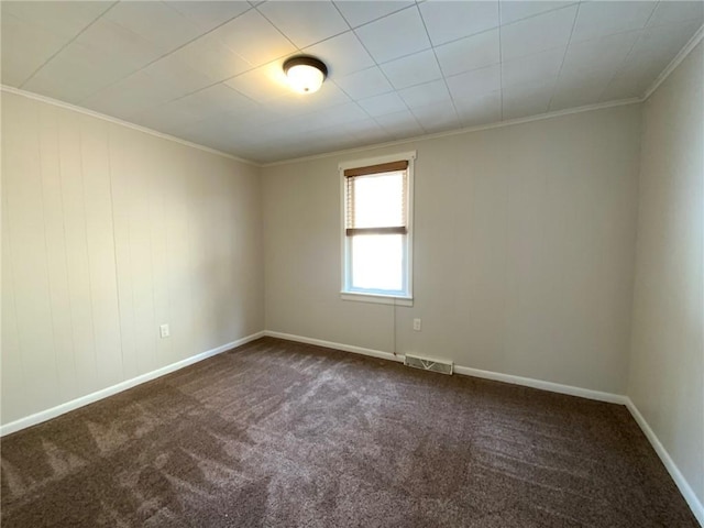 carpeted spare room featuring crown molding