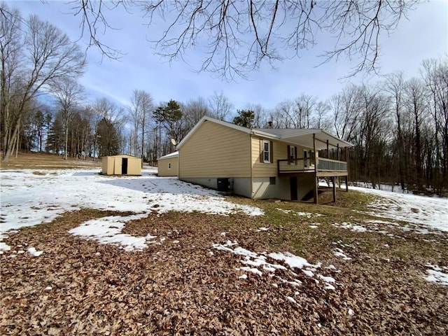 snow covered property with a storage unit