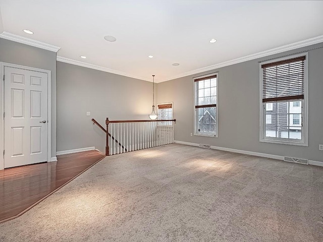 carpeted spare room with ornamental molding