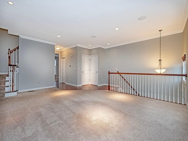 spare room with crown molding and carpet