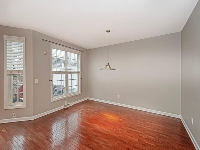 unfurnished dining area with dark hardwood / wood-style flooring