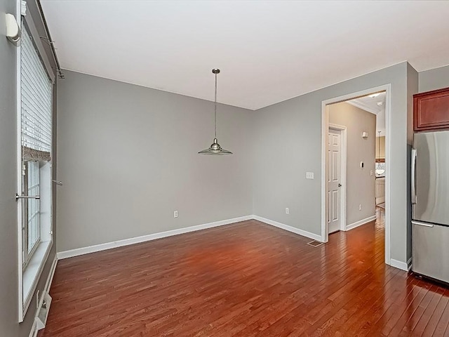 unfurnished dining area with dark hardwood / wood-style floors and a wealth of natural light