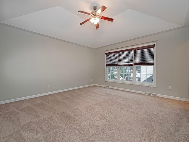 carpeted spare room featuring lofted ceiling and ceiling fan