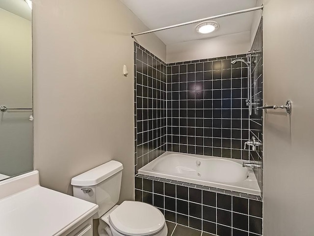 full bathroom with vanity, tiled shower / bath combo, and toilet