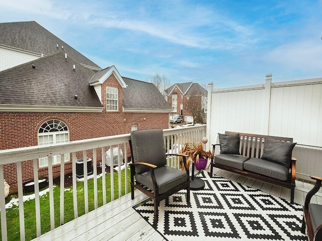 wooden deck featuring a yard and central air condition unit