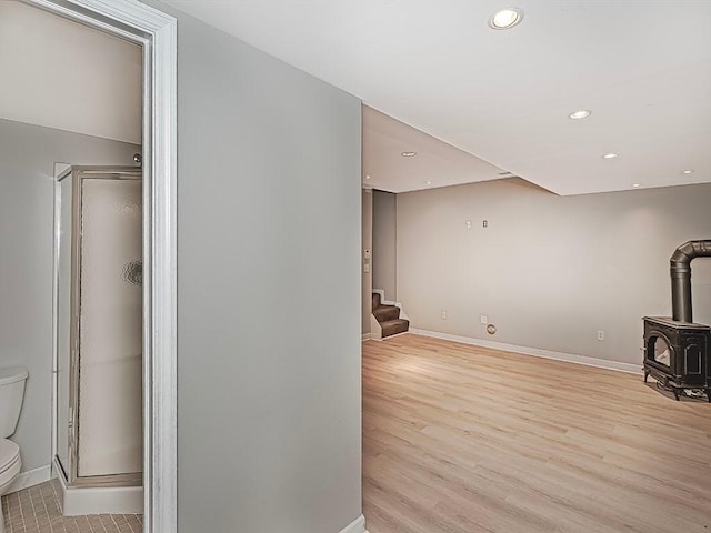 living room featuring light hardwood / wood-style floors and a wood stove