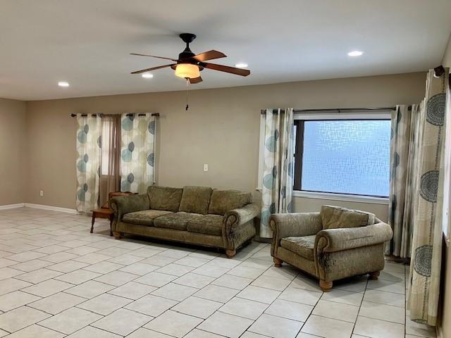 tiled living room with ceiling fan