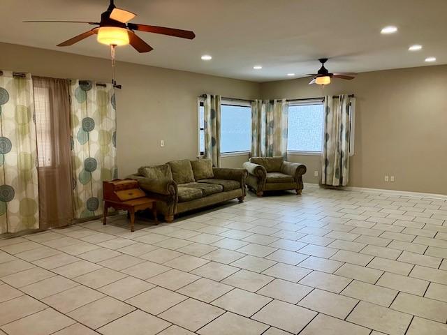 tiled living room featuring ceiling fan