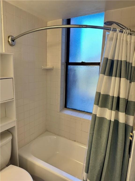 bathroom with toilet and shower / bath combo with shower curtain