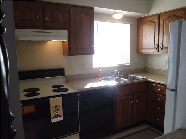 kitchen featuring sink, range with electric stovetop, white refrigerator, stainless steel fridge, and black dishwasher