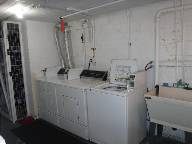 laundry room featuring sink and washer and dryer