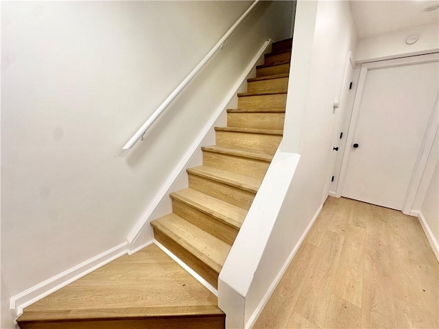 stairway featuring hardwood / wood-style flooring