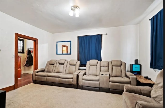 carpeted home theater featuring baseboards